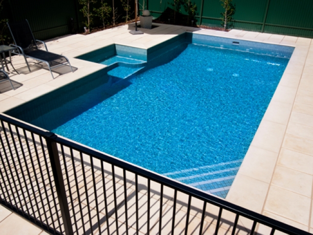 overhead view of custom pool with lounge setting and safety barrier
