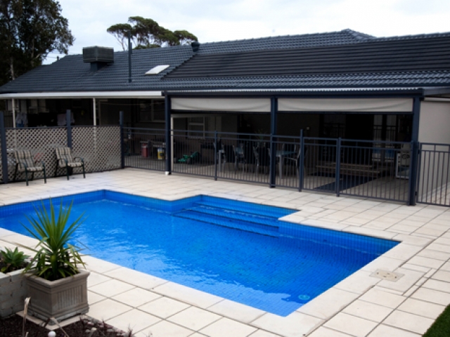 pool featuring overhead verandah and seating