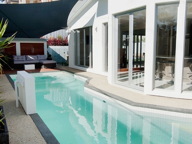 modern customised pool with stone border and upright water features