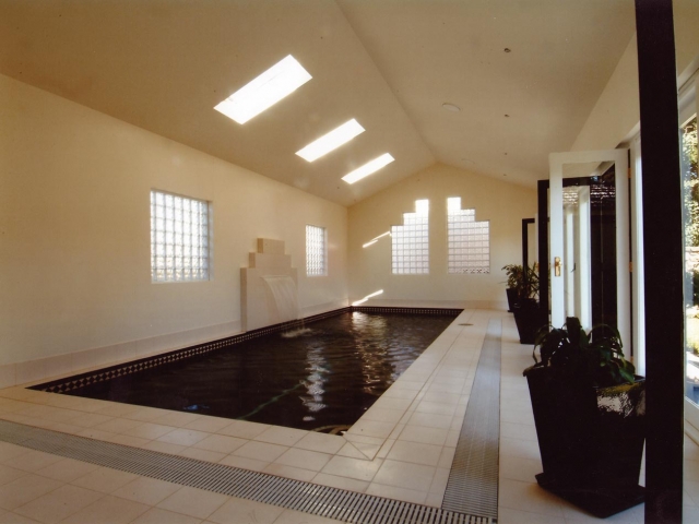 indoor pool with custom upright water feature fountain